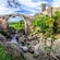A river flowing under a stone bridge that leads to the Castello dell’Abbadia in Vulci, Italy
